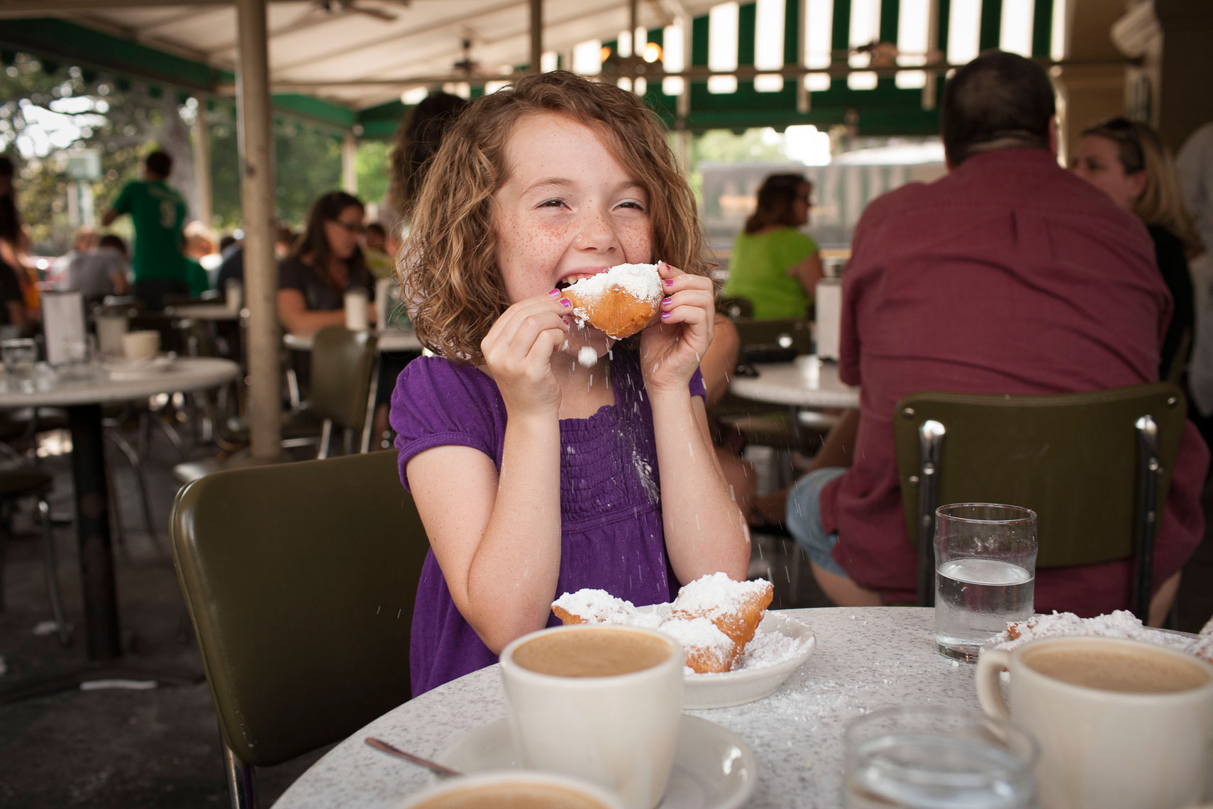 Callie Hirsch eating beignets at Cafe
