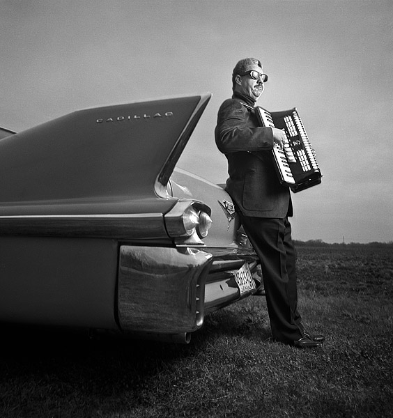 Lynn August with accordion and Cadillac